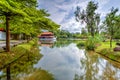 Yao-Yueh Fang Stone boat structure in a pound in Chinese Singapore garden with blue cloudish and reflection Royalty Free Stock Photo