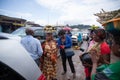 African female hawker with with baskets of food on their heads sell their products on the