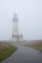 Yaquina Head Lighthouse in the fog. Oregon United States of America. Royalty Free Stock Photo