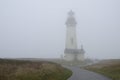 Yaquina Head Lighthouse in the fog. Oregon United States of America. Royalty Free Stock Photo