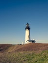 Yaquina Head Lighthouse, Oregon USA Against A Bright Blue Sky.