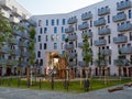 Yard area of a modern European residential complex, multi storey residential buildings with a playground and benches. Royalty Free Stock Photo