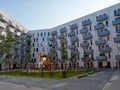 Yard area of a modern European residential complex, multi storey residential buildings with a playground and benches. Royalty Free Stock Photo