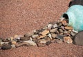 Yard art, rocks spilling from pottery