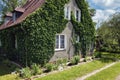 Yard of cozy ivy covered rural house at daytime Royalty Free Stock Photo