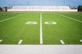 50 yard line on empty American football field stadium Royalty Free Stock Photo