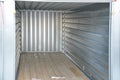 In the yard there is a large-capacity container with a wooden floor. serves as a garage, tool storage, or temporary home for conve