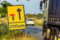 200 yards roadworks warning sign on UK motorway at evening with traffic passing Royalty Free Stock Photo