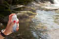 Yaremche Ukraine. 25 june 2021: Thermal water. Girl applying spray thermal water on nature background