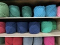 Yarn balls for knitting being arranged on a shelf in a store. Royalty Free Stock Photo