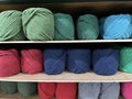 Yarn balls for knitting being arranged on a shelf in a store. Royalty Free Stock Photo