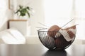 Yarn balls and knitting needles in metal basket on grey table indoors, space for text. Creative hobby Royalty Free Stock Photo