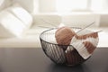 Yarn balls and knitting needles in metal basket on grey table indoors, space for text. Creative hobby Royalty Free Stock Photo