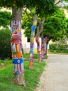 Yarn bombing in trees. European park. Royalty Free Stock Photo