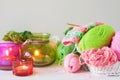 Yarn, candles, knitting on a white background wood. Pink and green colors. Royalty Free Stock Photo
