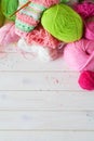 Yarn, candles, knitting on a white background wood. Pink and green colors. Royalty Free Stock Photo