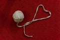 Yarn of wool in heart shape symbol with crochet hook Royalty Free Stock Photo