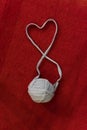 Yarn of wool in heart shape symbol with crochet hook Royalty Free Stock Photo