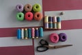 Yarns of threads for knitting in different colors on a pink and grey Royalty Free Stock Photo