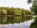 Yaroslavl. Warm evening in Neftyanik Park. Park refinery. Reflection of colorful sunset in the lake. Peace and quiet surrounded by Royalty Free Stock Photo