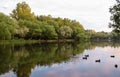 Yaroslavl. Warm evening in Neftyanik Park. Park refinery. Reflection of colorful sunset in the lake. Peace and quiet surrounded by Royalty Free Stock Photo