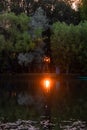 Yaroslavl. Warm evening in Neftyanik Park. Park refinery. Reflection of colorful sunset in the lake. Peace and quiet surrounded by Royalty Free Stock Photo