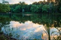 Yaroslavl. Warm evening in Neftyanik Park. Park refinery. Reflection of colorful sunset in the lake. Peace and quiet surrounded by Royalty Free Stock Photo