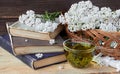 Yarrow herbal healing tea or decoction with fresh milfoil flowers and books