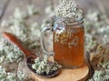 Yarrow.Herbal tea using dried yarrow flowers in a glass on a wooden background Royalty Free Stock Photo