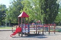 Yaslo, Poland - july 12 2018: Children`s playground in the park amidst greenery. Multicolored swings and buildings for children fr