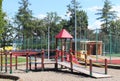 Yaslo, Poland - july 12 2018: Children`s playground in the park amidst greenery. Multicolored swings and buildings for children fr