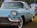 Yaslo, Poland - july 3 2018:a fragment of an old American classical cadillus of blue color. Front left headlight with bumper and c Royalty Free Stock Photo