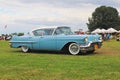 Yaslo, Poland - july 3 2018: Old American classical cadillac of blue color drives throuth a green. Backs headlight with bumper and