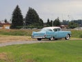 Yaslo, Poland - july 3 2018: Old American classical cadillac of blue color drives throuth a green. Backs headlight with bumper and