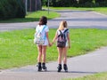 Yaslo, Poland - july 10 2018: Two girls rollerblading holding hands. Active lifestyle. Children on summer vacation. Fashionable ch