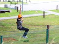 Yaslo, Poland - may 30 2018:A young paren climbs the trees in gear in a park for rock climbing. Scandinavian attraction for sports