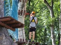 Yaslo, Poland - may 30 2018:A young paren climbs the trees in gear in a park for rock climbing. Scandinavian attraction for sports