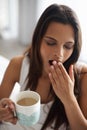 Yawn, tired and woman with coffee in bedroom with caffeine to wake up in morning at home. Exhausted, burn out and sleepy Royalty Free Stock Photo