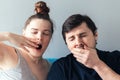 Yawning Caucasian couple with eyes closed. Man and woman, yawning and covering wide open mouth with hand. Tired and sleepy Royalty Free Stock Photo