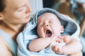 Yawning cutest baby after bath with towel on head. Royalty Free Stock Photo