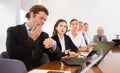 Middle aged white business man yawning at boring meeting Royalty Free Stock Photo