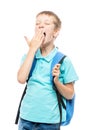 yawning schoolboy covers his mouth with his hand on a white Royalty Free Stock Photo