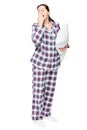 Yawning sleepy woman in warm pajamas holds ready pillow on white