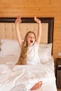 Yawns young girl phone mobile sleep beautiful bed eyes lying, for white relax from people for happy rest, positive light Royalty Free Stock Photo