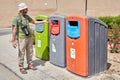 Tourist used coloured recycling wheelie bins for sorting waste,