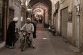 YAZD, IRAN - AUGUST 18, 2016: Iranian Imams wearing traditional clothes discussing while on a motorbike in a covered street of Yaz Royalty Free Stock Photo