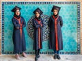 Three iranian newly graduated student girls infront of a wall tile of Jameh Mosque of Yazd, Iran