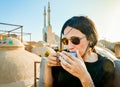 Yazd, Iran - 19th june, 2022: female caucasian tourist drink persian coffee in traditional rooftop cafe relax enjoy panoramic