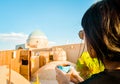 Yazd, Iran - 19th june, 2022: female caucasian tourist drink persian coffee in traditional rooftop cafe relax enjoy panoramic