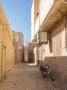 Two motorcycyles standing in a typical street of the old town of Yazd, iran, with its typical clay walls Royalty Free Stock Photo